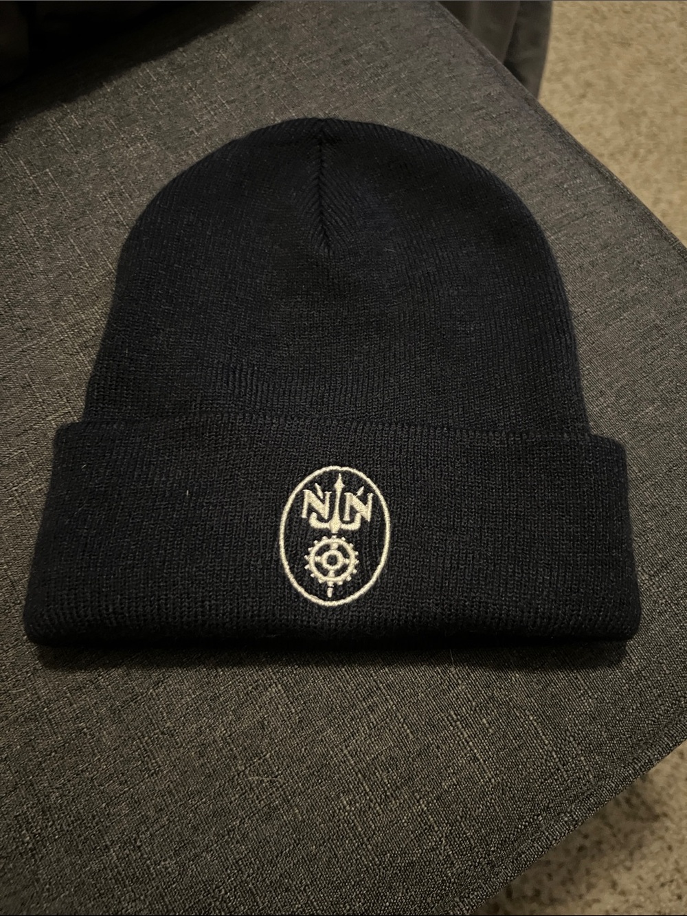 Port and Company Black Beanie with White Embroidered Crest Newport News Ship